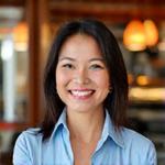 Portrait of Ms. Maria Santos, a successful restauranteur and brand strategist, smiling warmly.